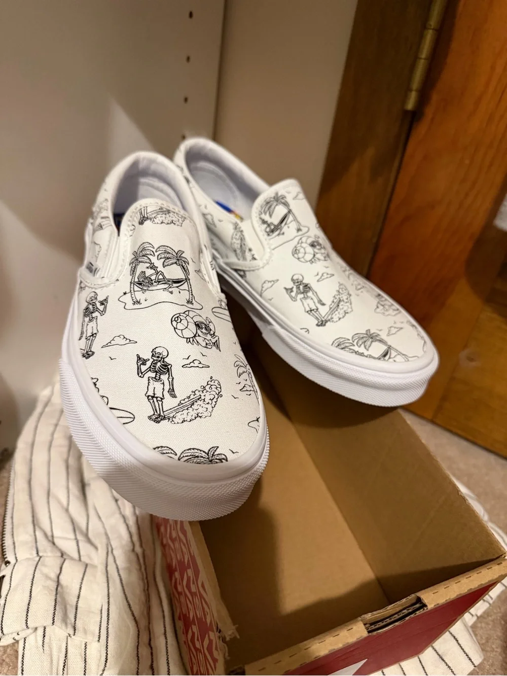 Vans White Slip-On Sneakers with Black skeleton doodles